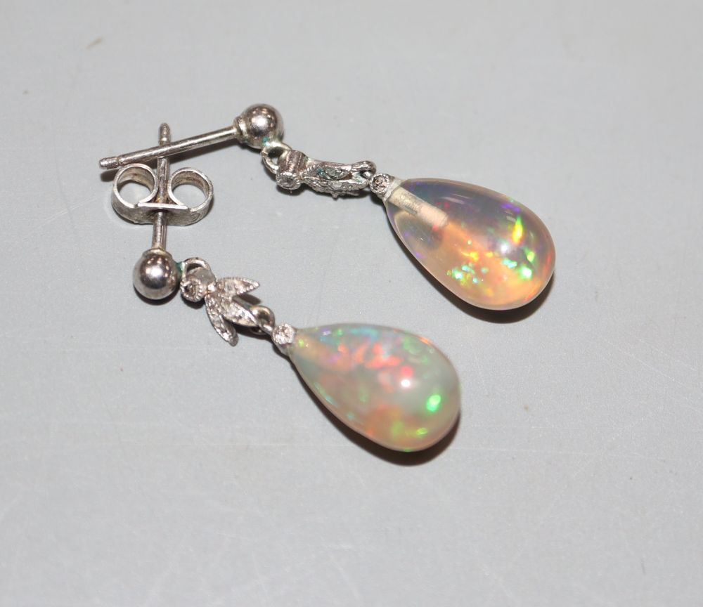 A pair of white metal, pear shaped opal and diamond set drop earrings, 25mm, gross 2.3 grams.